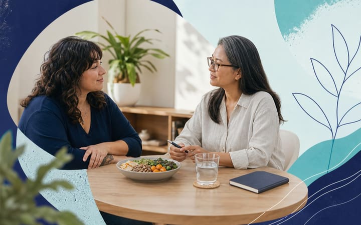 A person having a calm, supportive conversation with two health professionals beside a simple meal and notebook